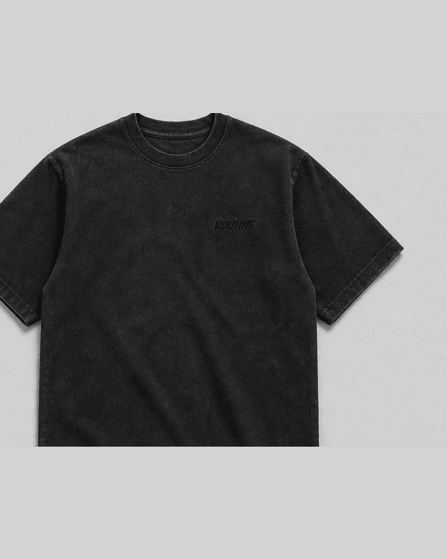 Washed black heavyweight tee with a small tonal ROUTINE script on the chest.