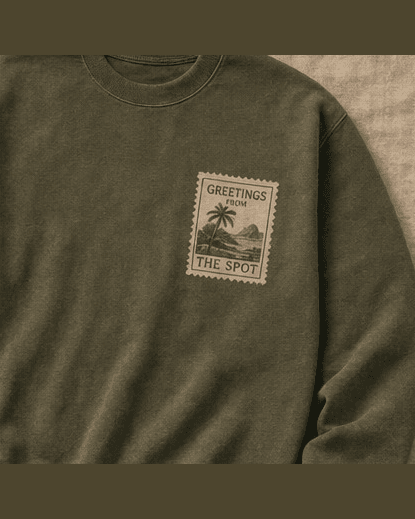 Olive El Spot crewneck with a Greetings from The Spot stamp on the chest.