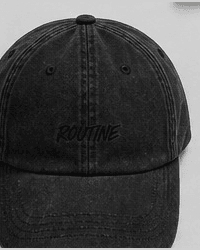 Washed black dad hat with a tonal ROUTINE script on the front.