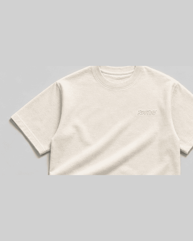 Cream heavyweight tee with a small tonal ROUTINE script on the chest.