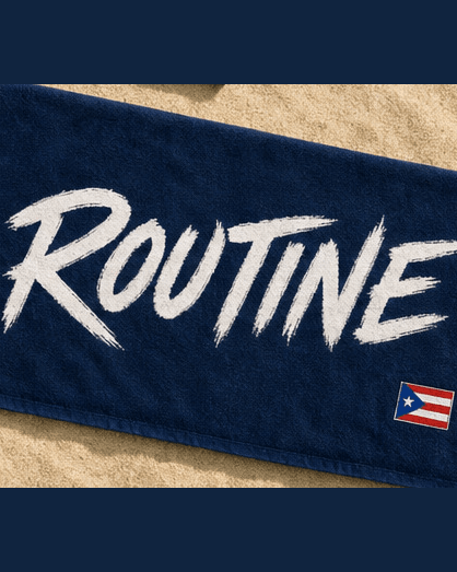 Navy La Isla beach towel with a large white ROUTINE script and a flag in the corner.