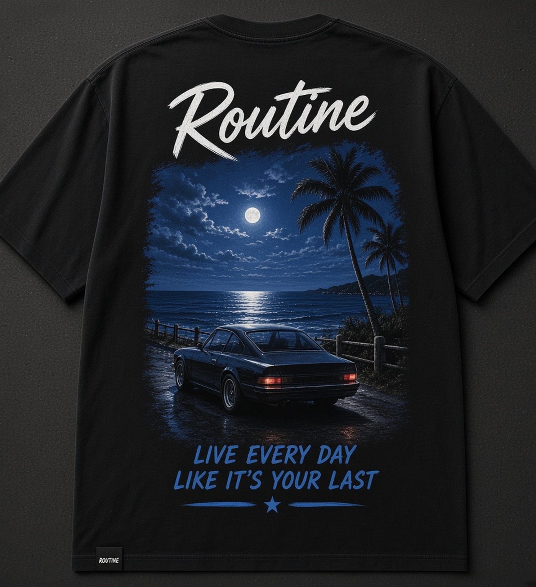 Back of a washed black Routine tee. Brush script ROUTINE above a moonlit ocean lookout print with a parked car, palms, and the tagline Live every day like it's your last.