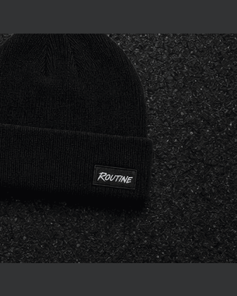 Black Night Drive beanie with a small woven ROUTINE label on the cuff.