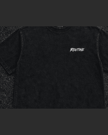 Front of the washed black Night Drive tee with a small white ROUTINE script on the chest.